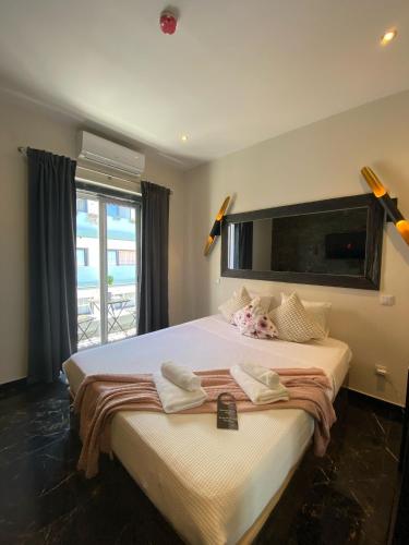a bedroom with a large bed with towels on it at AL Barbinha in Faro