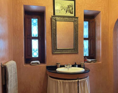 a bathroom with a sink and a mirror at Villa Sophia in Azib Oulad Lâdem