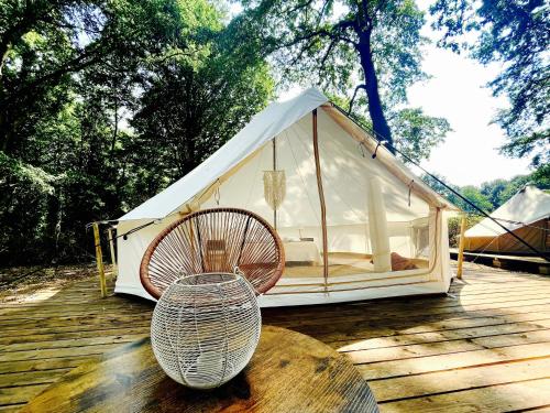 a white tent with a chair on a wooden deck at OAK Glamping Relax in Manziana