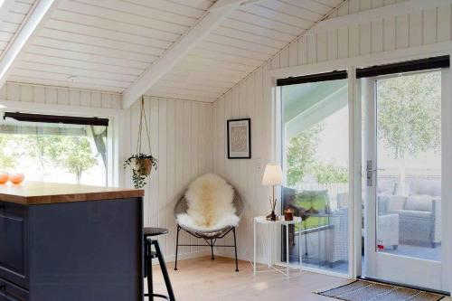 a kitchen with a counter and a chair in a room at Holiday Home With Fjord Views In Hjarbæk in Løgstrup
