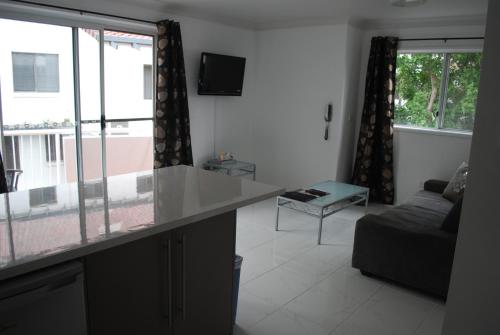 a living room with a counter and a couch at Costa D'Ora Holiday Apartments in Gold Coast