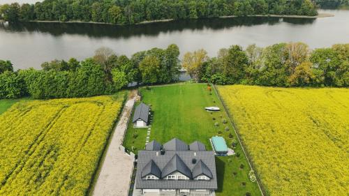 an aerial view of a house in a field next to a river at MAŁY PORT-Iława - Jezioro - Plaża - Marina priv - 5 pokoi VIP - czysto na 10 in Iława