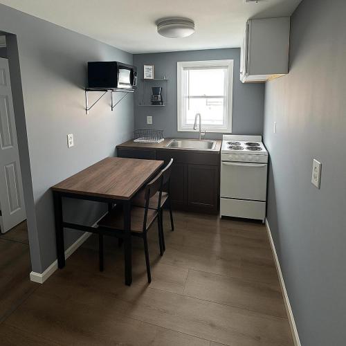 a kitchen with a table and a sink and a stove at Atlantic Breeze Motel & Apartments in Ocean City