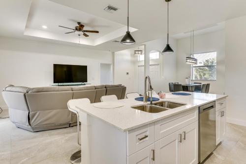 a kitchen with a sink and a couch at Day Trip to Beach and Manatee Park Lehigh Acres Gem in Lehigh Acres