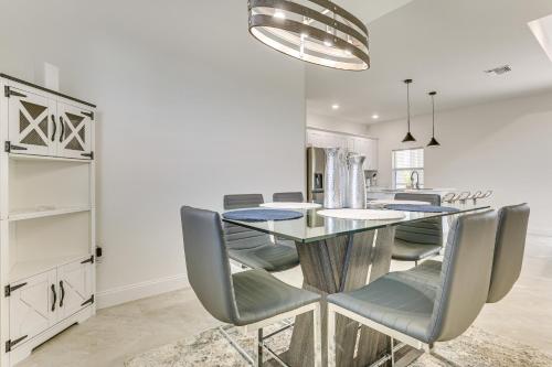 a dining room with a glass table and chairs at Day Trip to Beach and Manatee Park Lehigh Acres Gem in Lehigh Acres