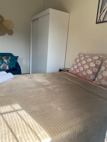 a bedroom with a large bed and a sliding door at Apartamento cachoeira in Florianópolis