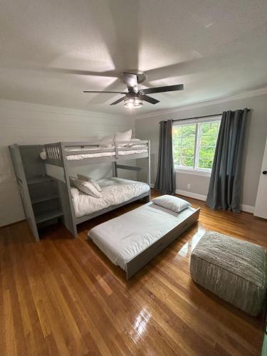 a bedroom with two bunk beds and a ceiling fan at The Nest in Mobile