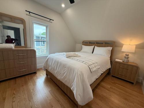 a bedroom with a large bed and a mirror at Boston First floor condo in Framingham
