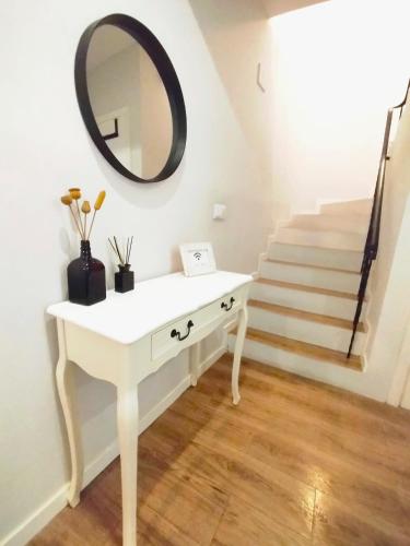 a white dressing table with a mirror and stairs at Casa de São Roque Açores in Ponta Delgada