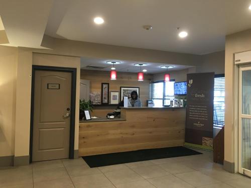 a waiting room with a counter and a door at Country Inn & Suites by Radisson, Camp Springs Andrews Air Force Base , MD in Camp Springs