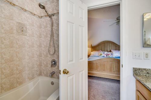 a bathroom with a tub and a bedroom with a bed at 15 Mi to Melbourne Beach Peaceful Palm Bay Escape in Palm Bay