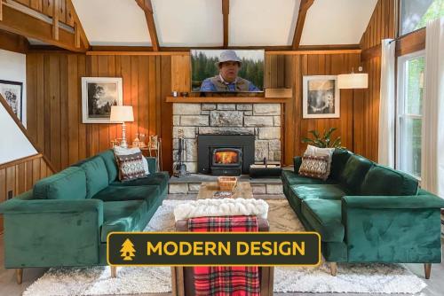 un hombre de pie en una sala de estar con chimenea en Heidi's Chalet - Modern Hot Tub Lake Access, en Pocono Lake