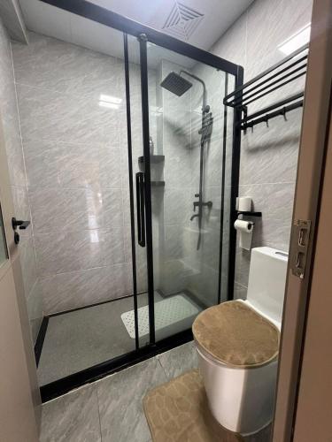 a bathroom with a glass shower with a toilet at Urban Host Pro in Nairobi