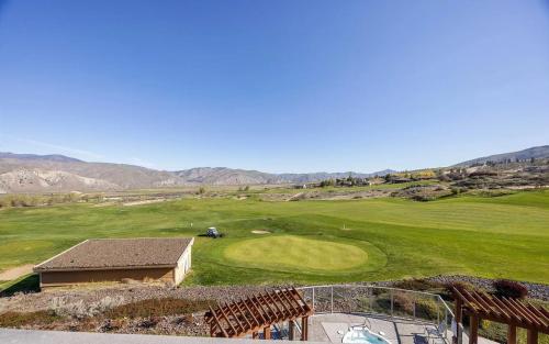 an aerial view of a golf course with mountains in the background at Desert Canyon Golf Resort in Orondo