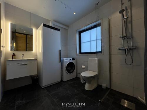 a bathroom with a toilet and a sink and a window at Lindvallen Ski Resort Pool and Padel - Sauna - 8 Guests in Sälen