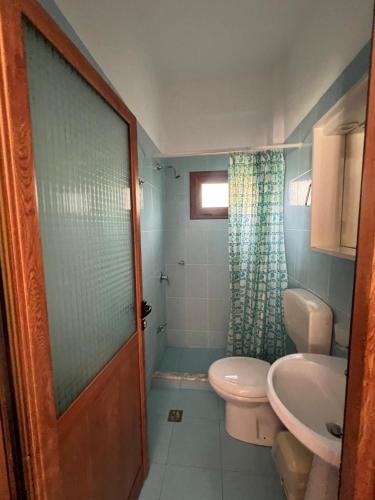 a bathroom with a toilet and a sink at Amare Apartaments in Orikum