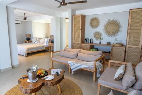 a living room with a couch and a table at Kaskazi Hotel Zanzibar in Jambiani