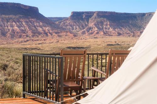 a couple of chairs sitting on a porch with a tent at Zion Wildflower Resort in Virgin