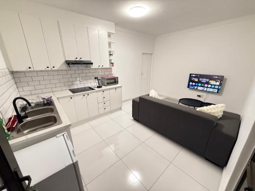 a kitchen with a couch in the middle of a room at 268 Self-catering Apartments in Swakopmund