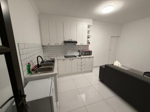 a white kitchen with a sink and a counter at 268 Self-catering Apartments in Swakopmund