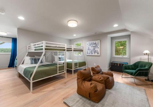 a bedroom with two bunk beds and a couch at Stone Point Overlook in Mooresville