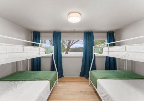 two bunk beds in a room with a window at Stone Point Overlook in Mooresville