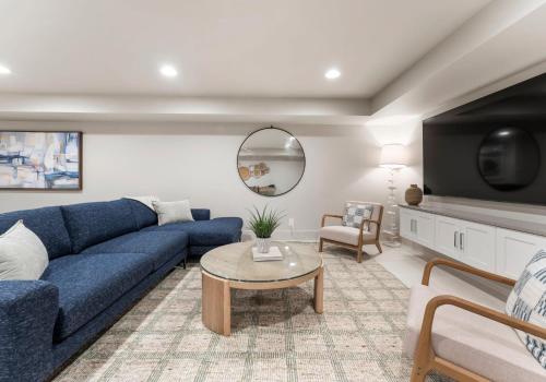 a living room with a blue couch and a tv at Stone Point Overlook in Mooresville