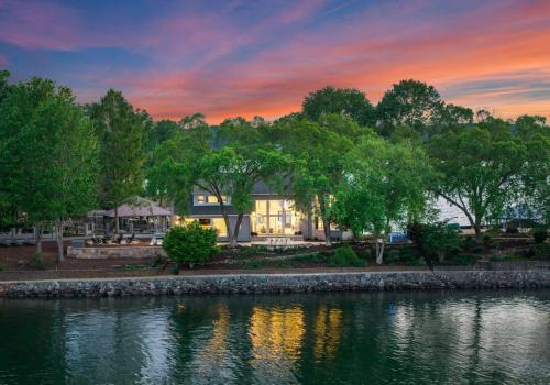 a house on the shore of a lake at sunset at Stone Point Overlook in Mooresville
