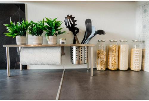 a table with potted plants and utensils on it at Stadthaus im Altstadtkern für bis zu 8 Personen in Dingolfing