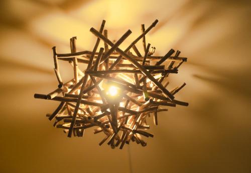 a chandelier made out of wooden sticks at La Maison du Marché in Saint-Pierre