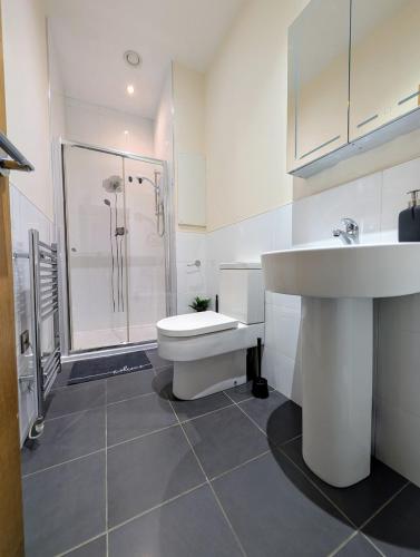 a bathroom with a sink and a toilet and a shower at Apartment in West Yorkshire in Huddersfield