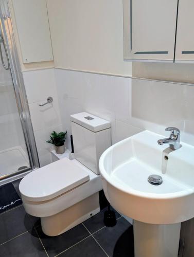 a bathroom with a white toilet and a sink at Apartment in West Yorkshire in Huddersfield