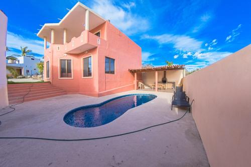 a house with a swimming pool in front of it at Casa Ohana, Mayto in Maito