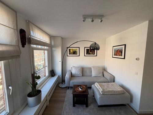 a living room with a couch and a table at Cozy Home in The Oude Pijp in Amsterdam