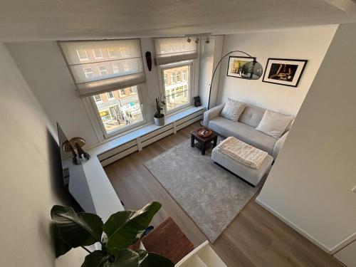 an overhead view of a living room with a couch and two windows at Cozy Home in The Oude Pijp in Amsterdam