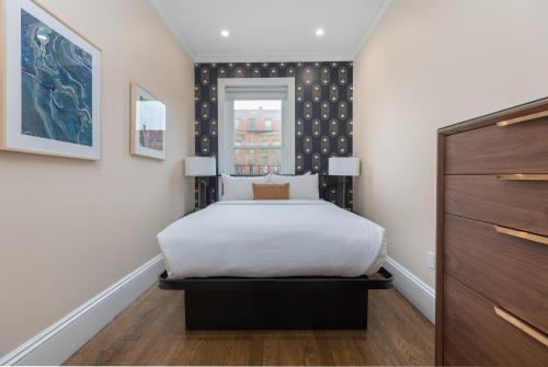 a bedroom with a bed and a window at 304 Newbury Street by Thatch in Boston