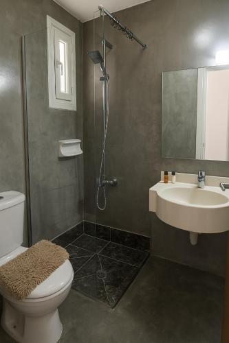 a bathroom with a toilet and a sink and a shower at Summer's Hotel Apartments in Ayia Napa