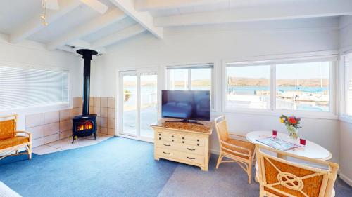 a living room with a television and a stove at Tomales Bay Lodge and Marina Inc in Inverness