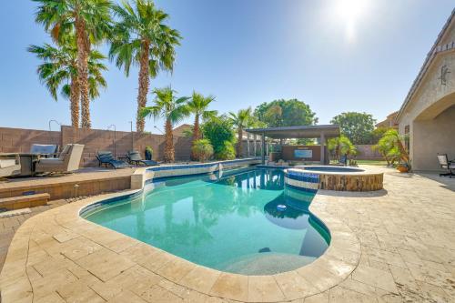 a swimming pool in a yard with palm trees at Swim-Up Bar and Putting Green Goodyear Getaway! in Goodyear