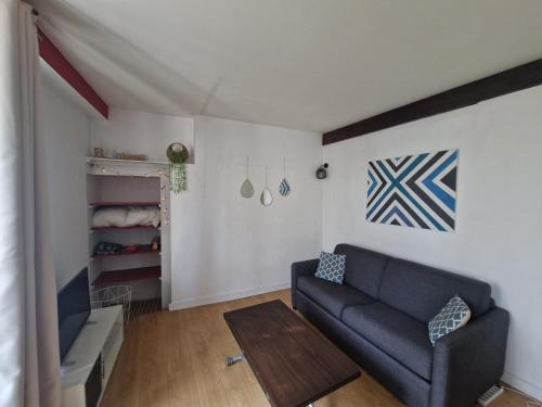 un salon avec un canapé et une table dans l'établissement 2 pièces hyper centre de La Rochelle, proche du port et de la plage, à La Rochelle