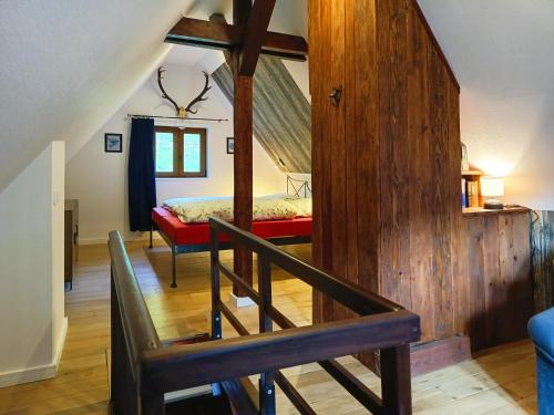 a bedroom with a bed and a wooden floor at Kuckucksnest - Nid de Coucou in Sondernach