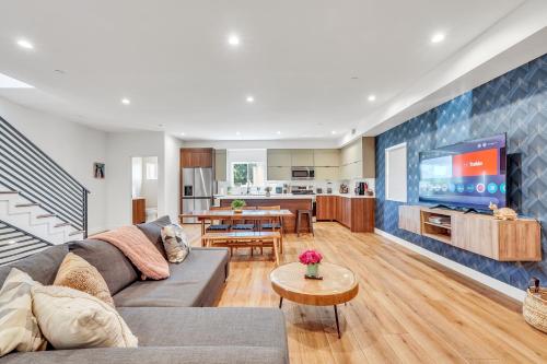 a living room with a couch and a tv at Luxurious Townhome W/3 Master Suites gated Parking in Los Angeles