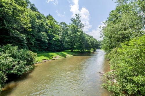 a river with trees on both sides of it at Riverside Mountain Retreat in Boone