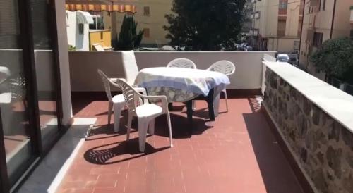 a patio with a table and chairs on a balcony at La Terrazza in Albissola Marina