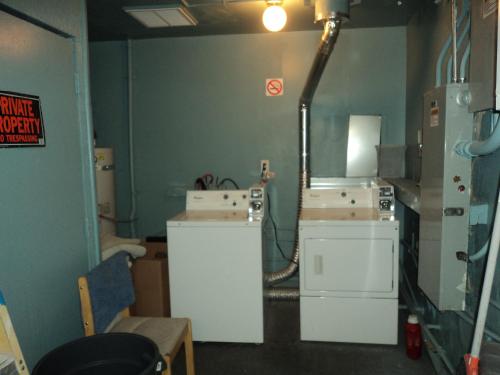 a room with a room with boxes on the wall at Travelers Bed & Breakfast Hostel in Las Vegas