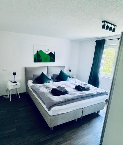 a bedroom with a large bed with blue pillows at Soulmates Resorts - Feldberg in Feldberg