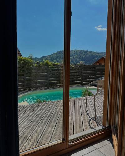 a view from a window of a deck with a pool at Chalet 3 Vallées - Piscine & SPA - Haut Standing in Rupt-sur-Moselle