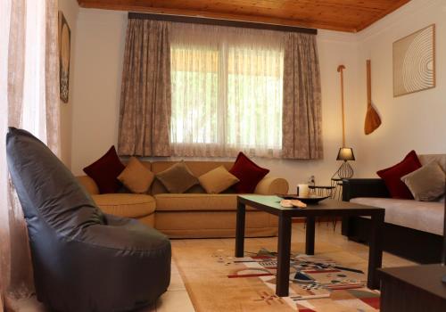 a living room with a couch and a table at Charming Villa by the Sea in Nea Kalikratia