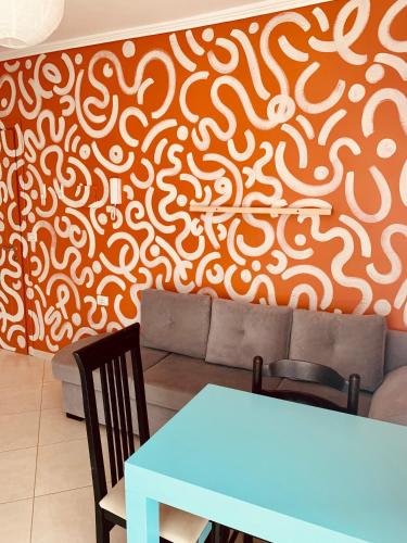 a dining room with an orange and white wall at Family Tree - WATER Available - SELF check in in Golem