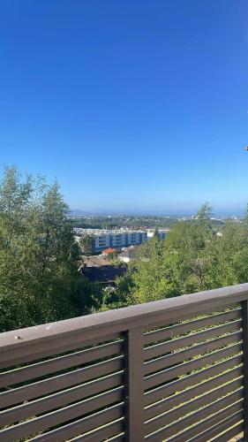 a wooden fence with a view of a city at Flott sted med utsikt over hele byen in Stavanger